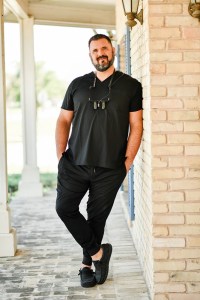 Dr. Panos posing outside of office building